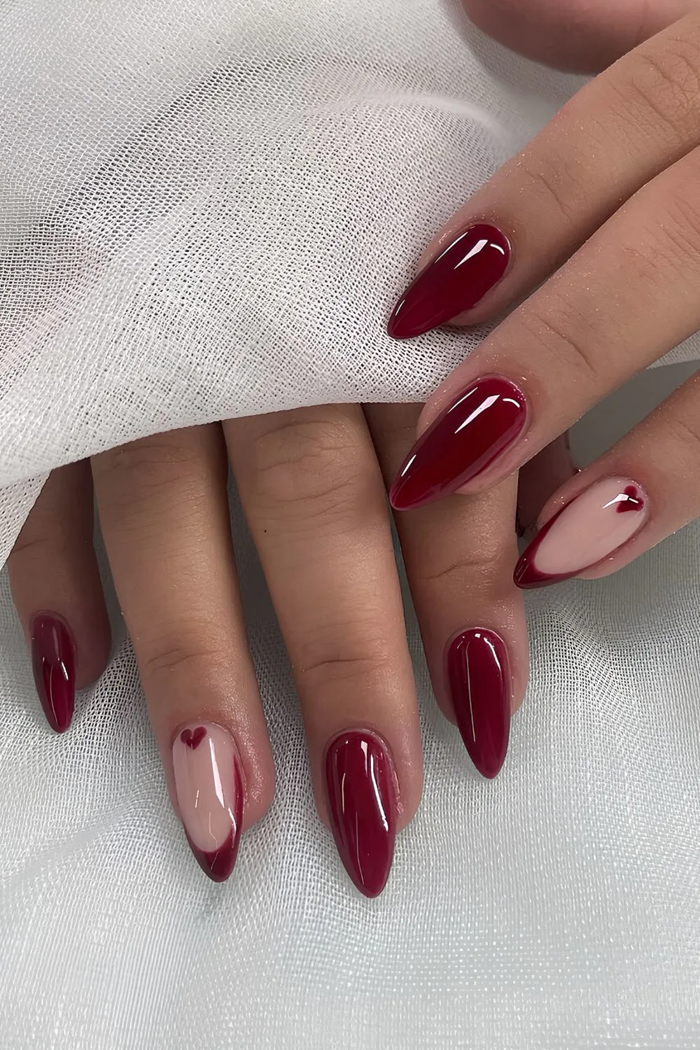 Cherry red nails with heart accents